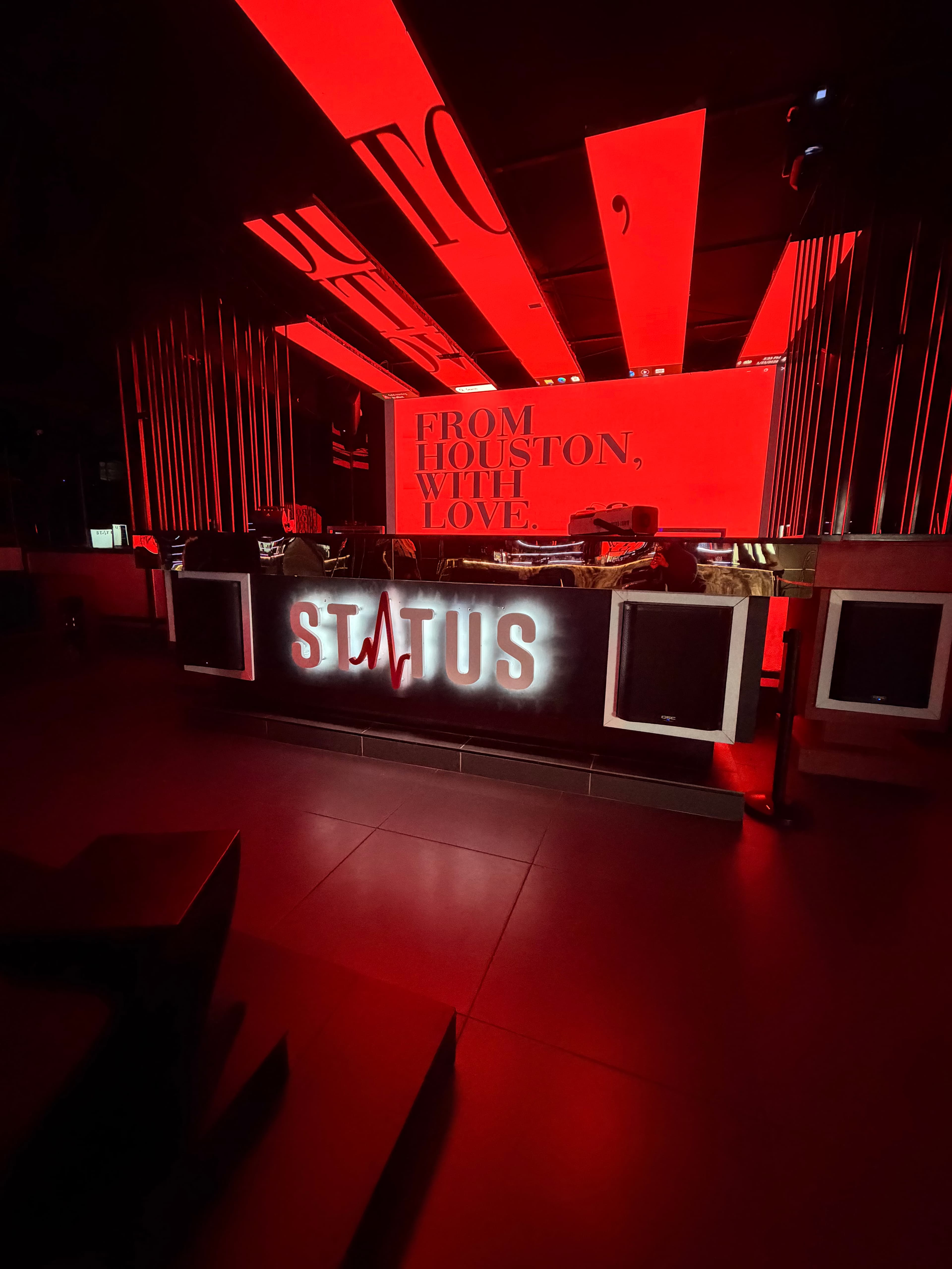 Status DJ booth beneath the venue's red light installation